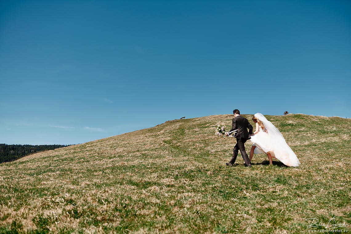 bride and groom walking in the nature