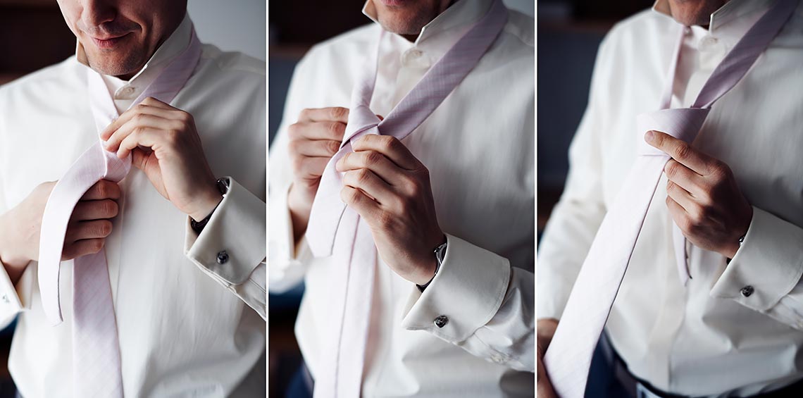 groom tieing his tie