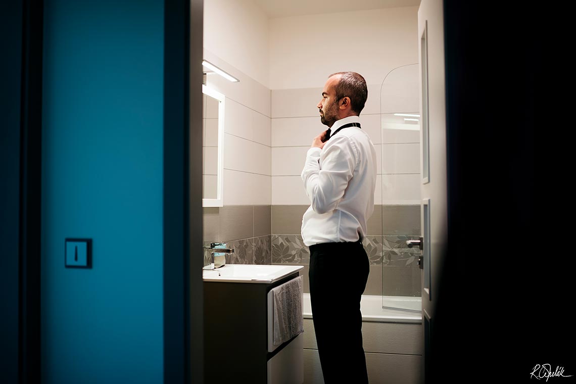 groom getting ready in the bathroom