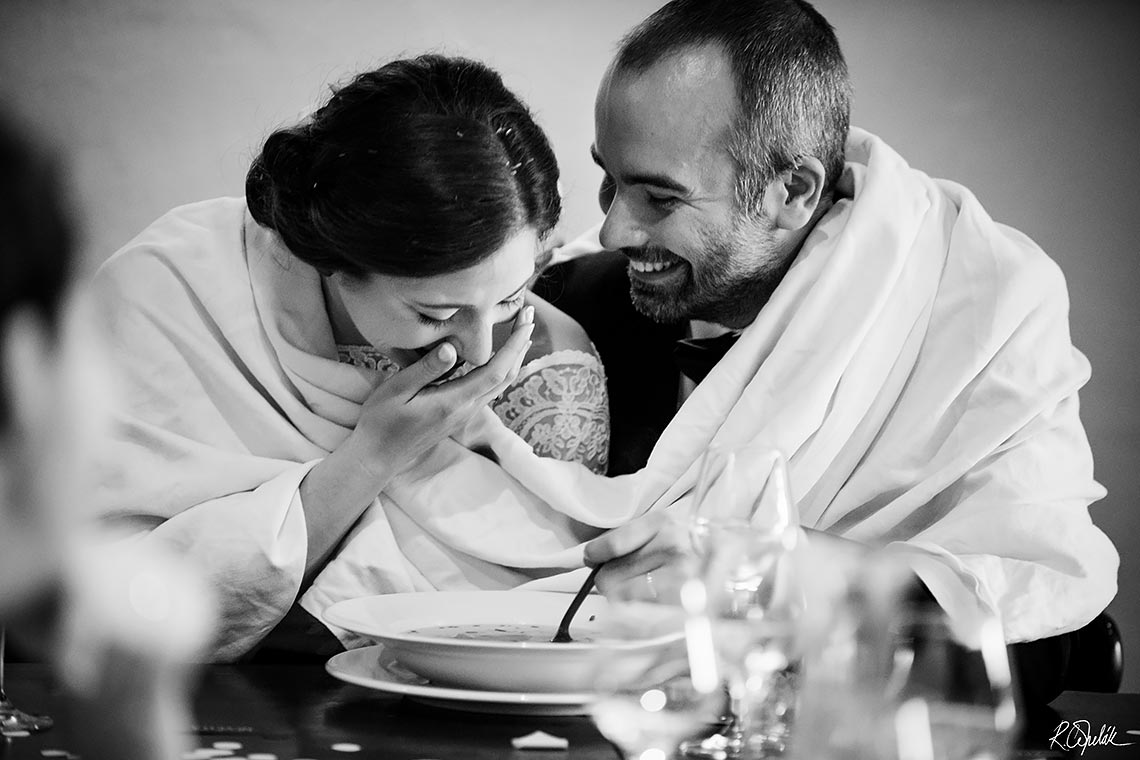 black and white photo of bride and groom eating the soup