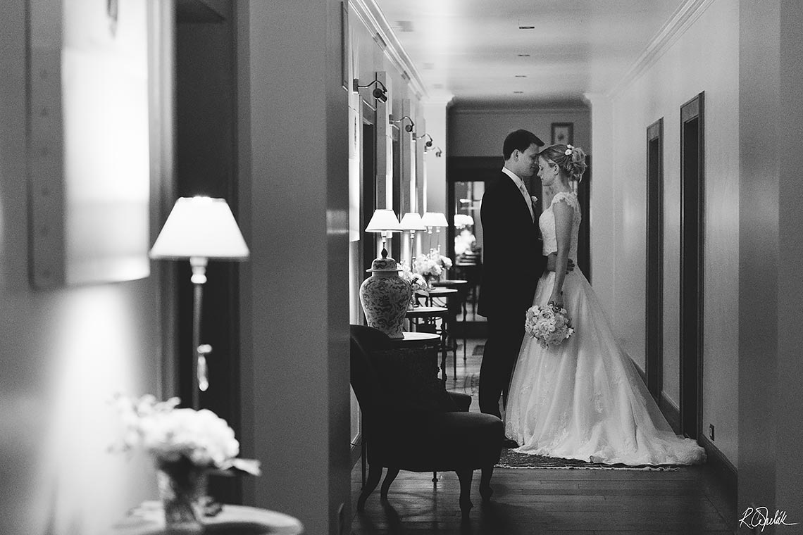 wedding potography of bride with groom at corridor of hotel Chateau Mcely in Czech republic
