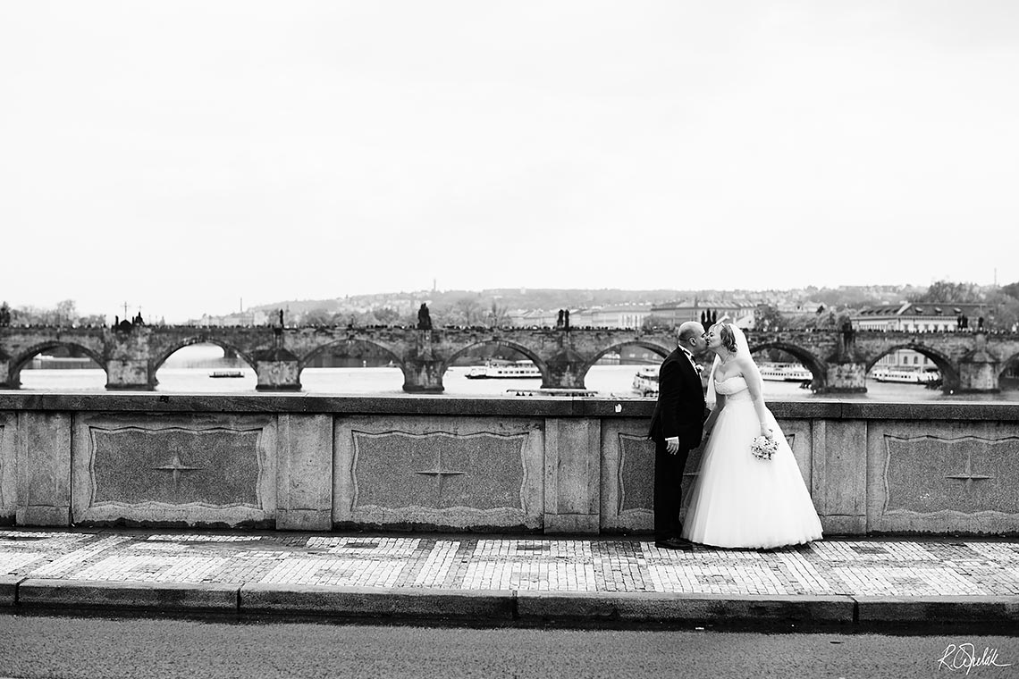 kissing bride and groom black and white photo