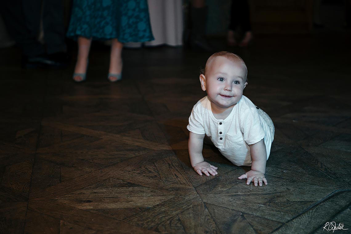 funny snapshot of baby on the dance floor at wedding