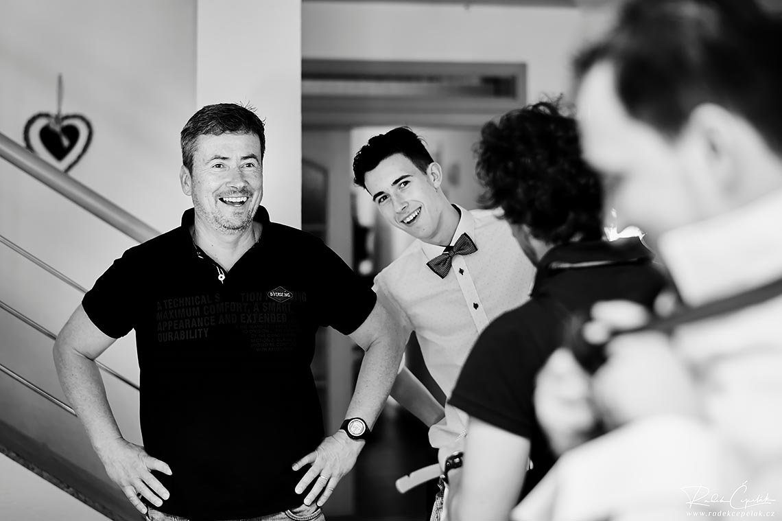 groom's father and brother are smiling during getting ready