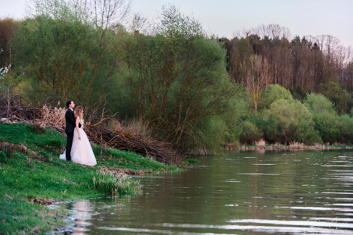 bride and groom by the lake wedding photography
