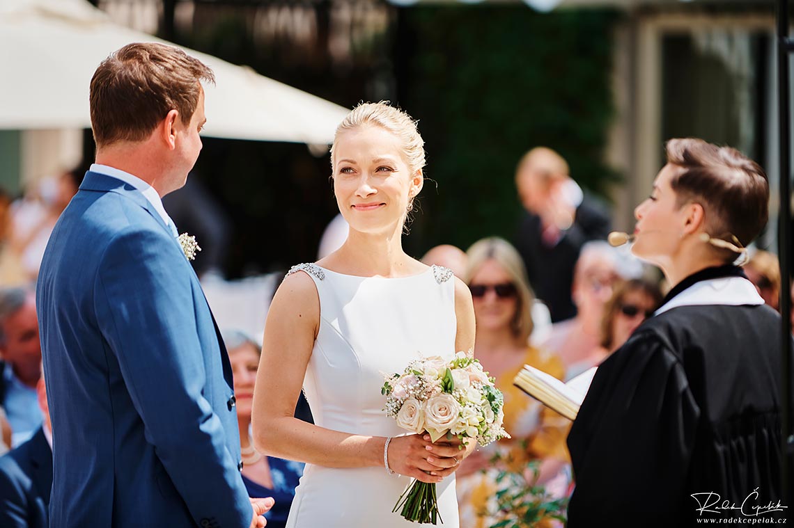 Bride smiling at groom during wedding ceremony in Prague
