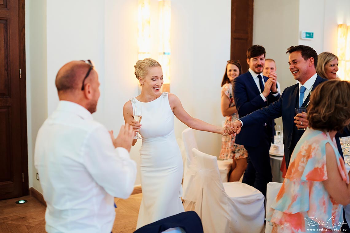 bride and groom enterin wedding reception in hotel