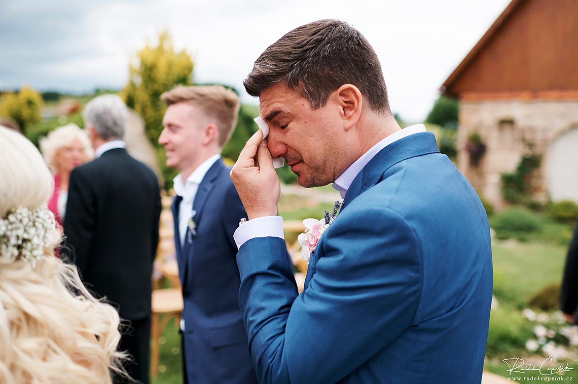 Touching groom crying photo after ceremony.