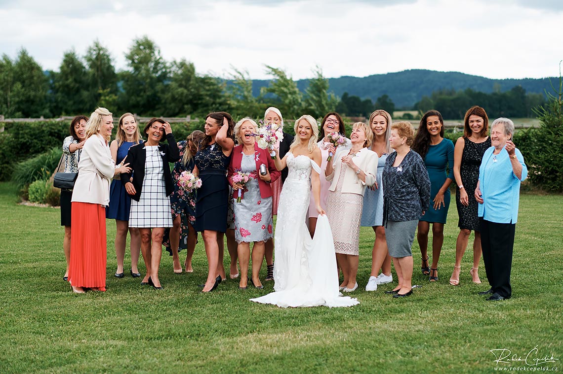 group smiling photo of bride with her friends and family