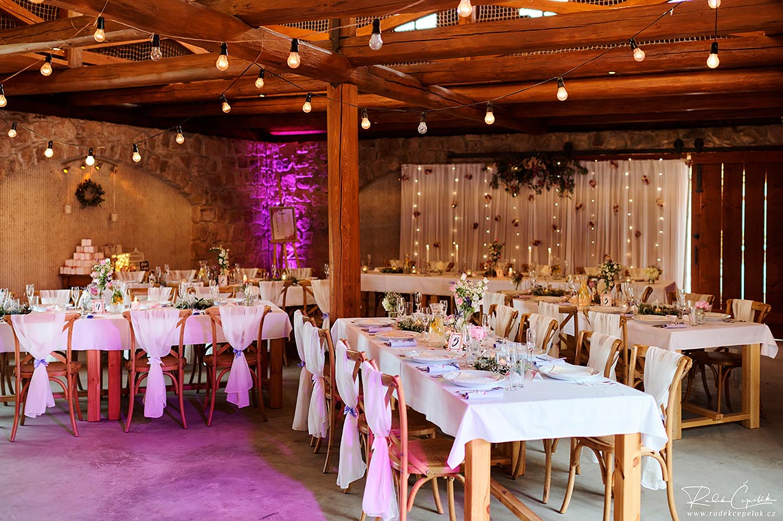 Table setup at wedding in Hejtmankovice barn in Czech republic