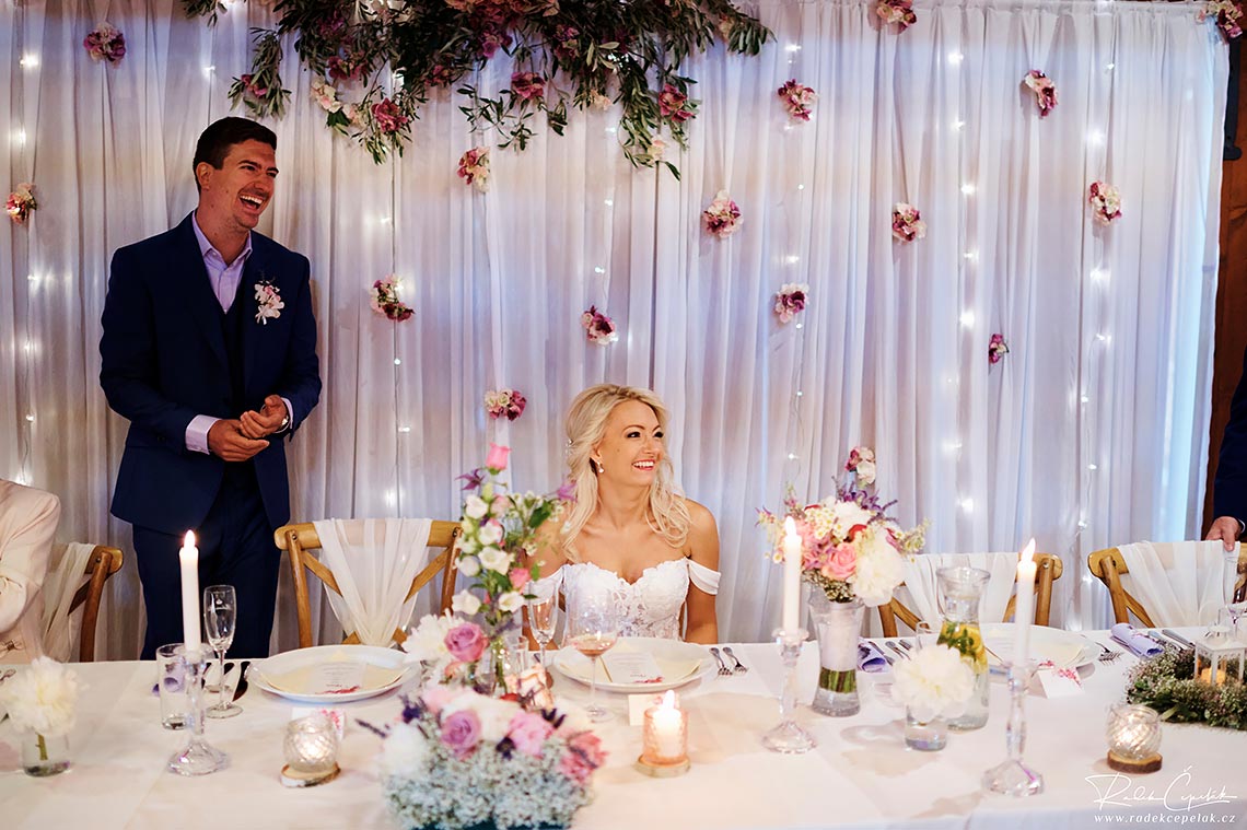 Bride and groom laughing during beginning of wedding reception