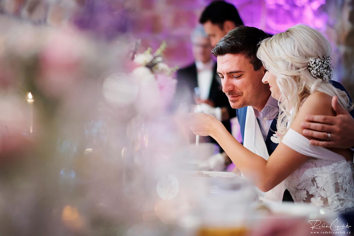 Bride feeding groom with soup