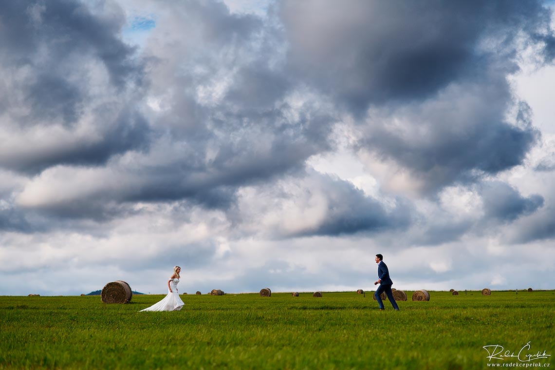 Bride running against the groom on the field