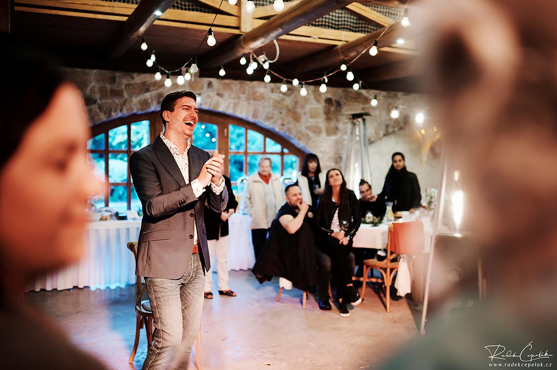 Groom is laughing on wedding evening party