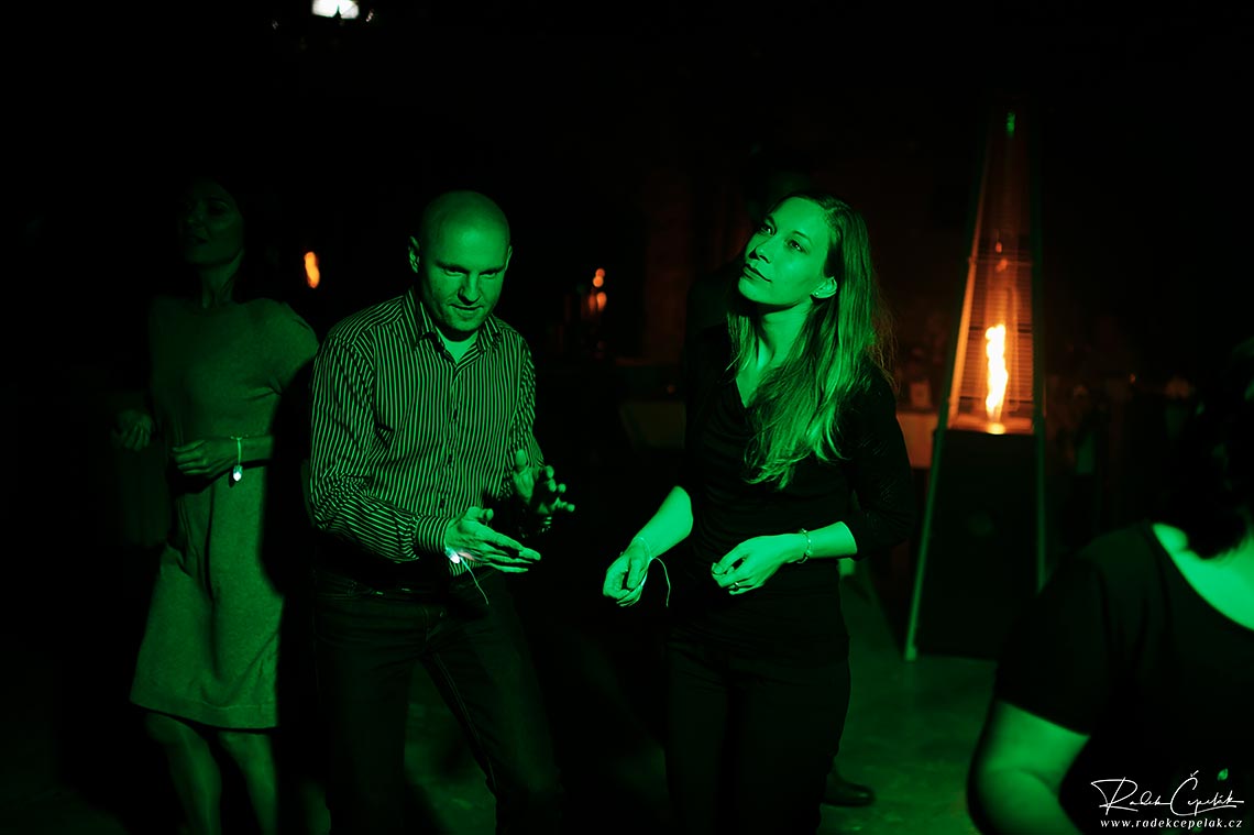 Wedding guests dancing under green light