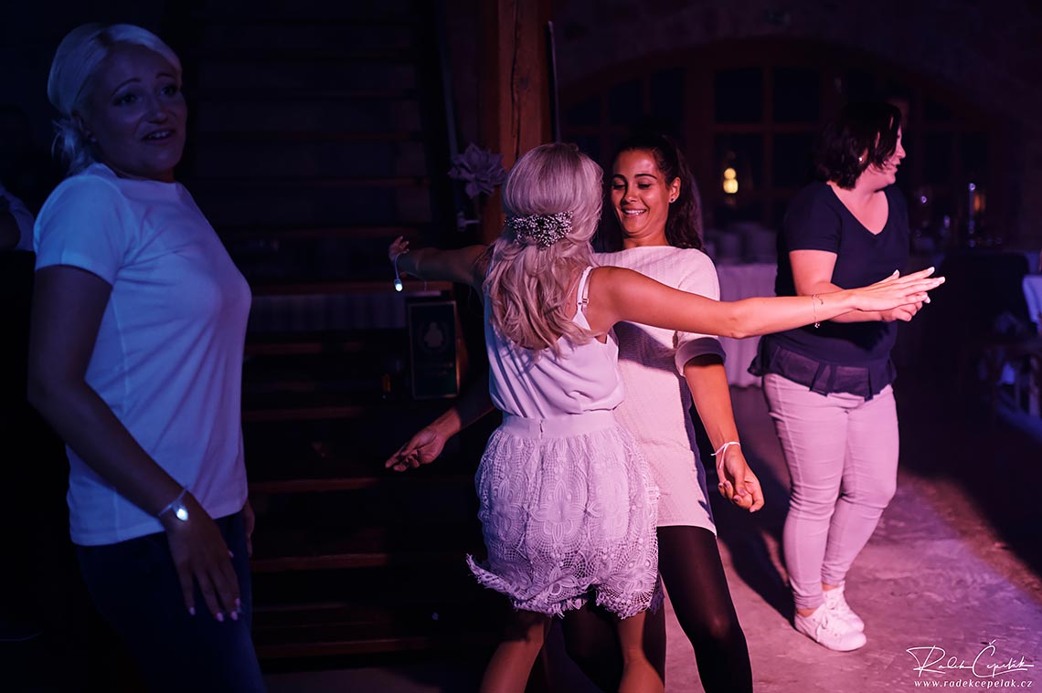 Bride is dancing with her friend at dance floor