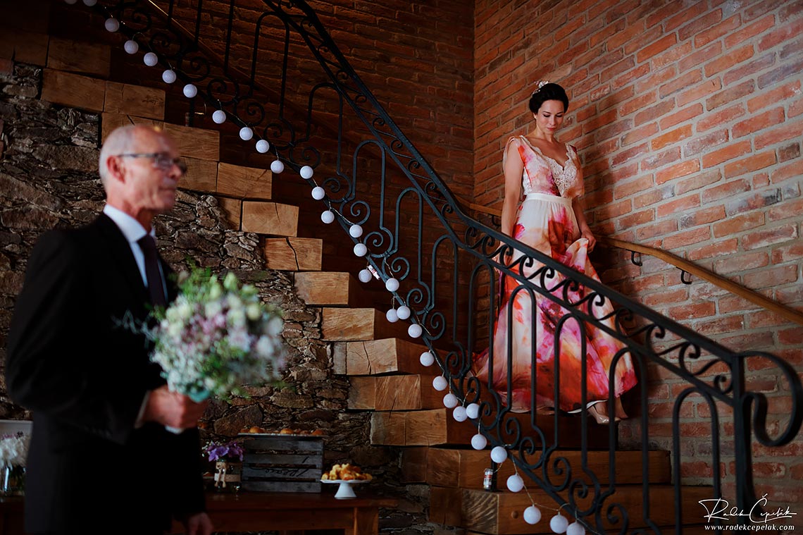 bride walking down the stairs to her father