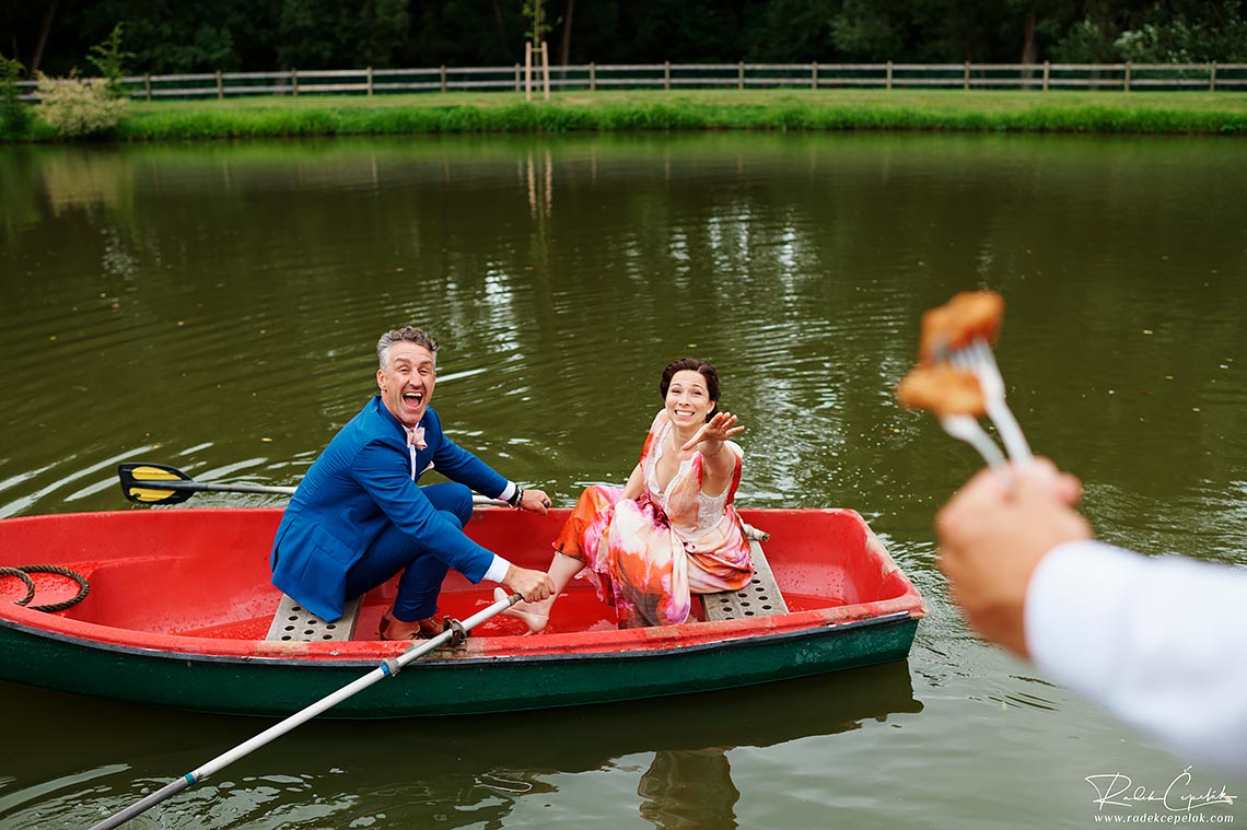 funny wedding photography of bride and groom trying to reach food