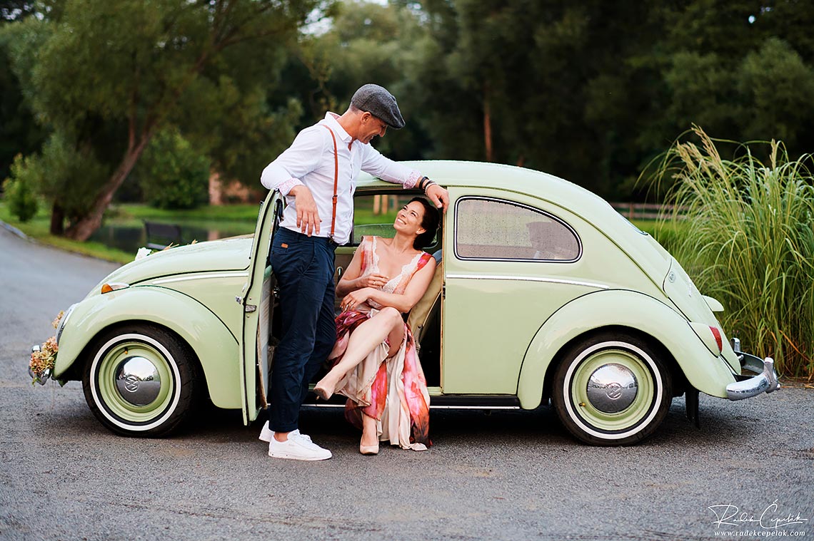 Bride and groom with mint old vintage car VW Beatle