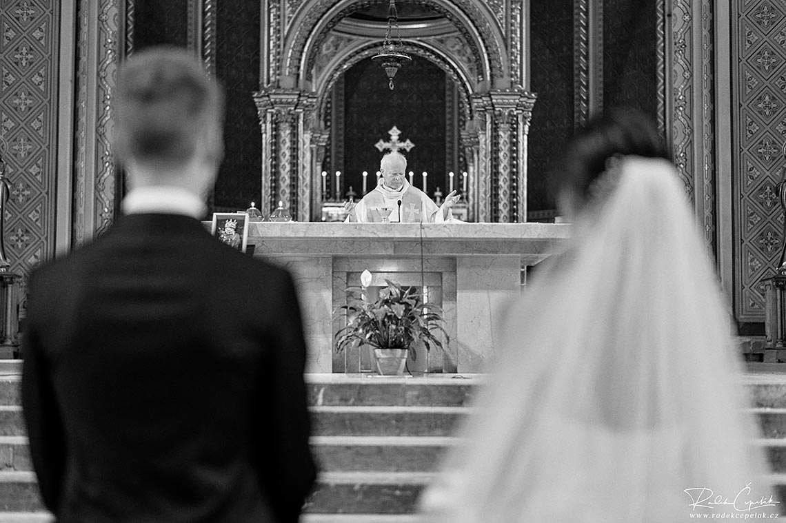 black and white wedding ceremony photo of priest