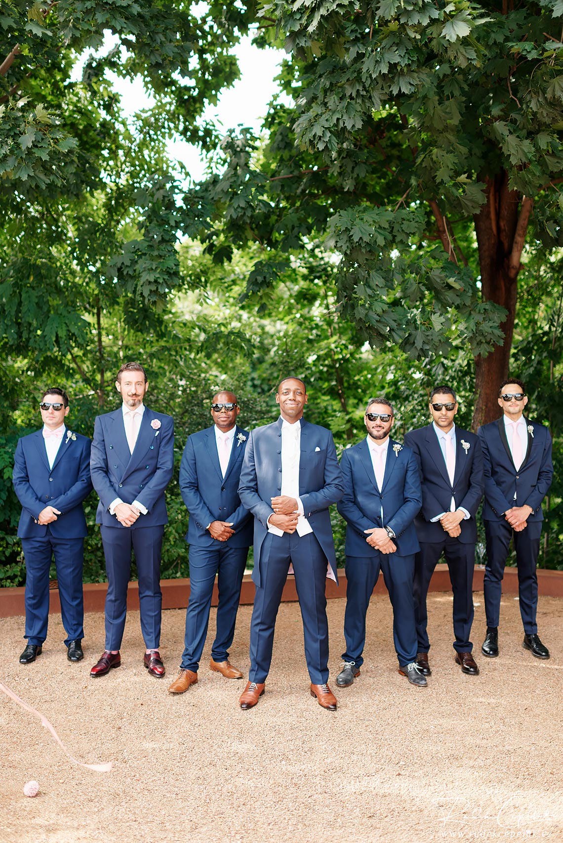 groom with groomsman in blue suites