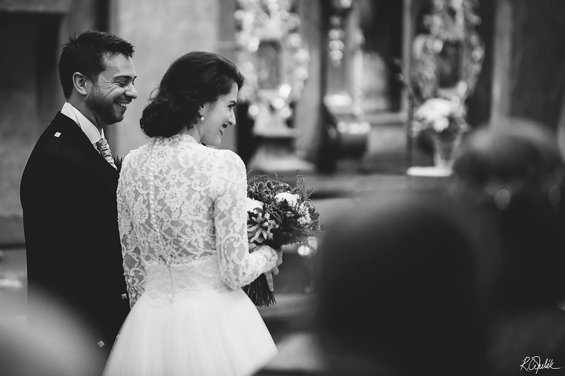 bride and groom during wedding ceremony in church St. Thomas in Prague