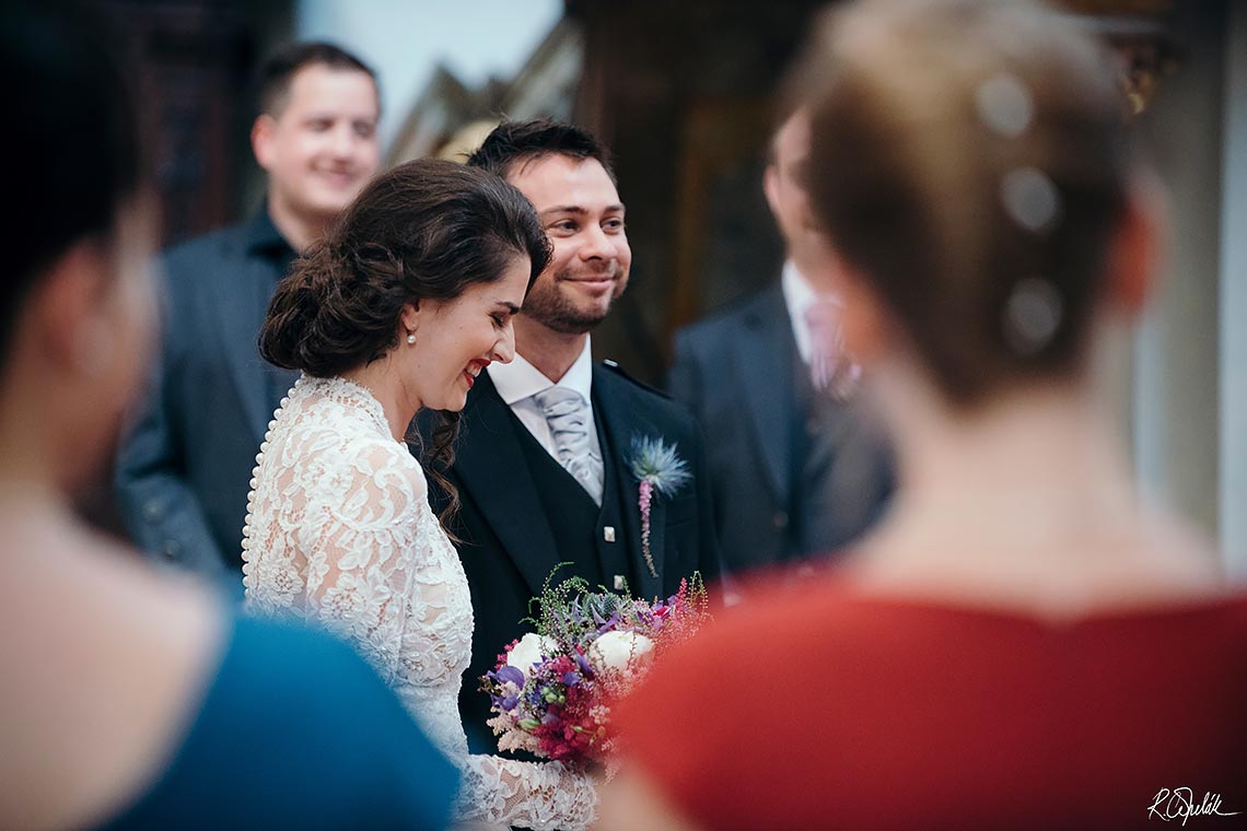 smiling bride at wedding ceremony in church St. Thomas in Prague