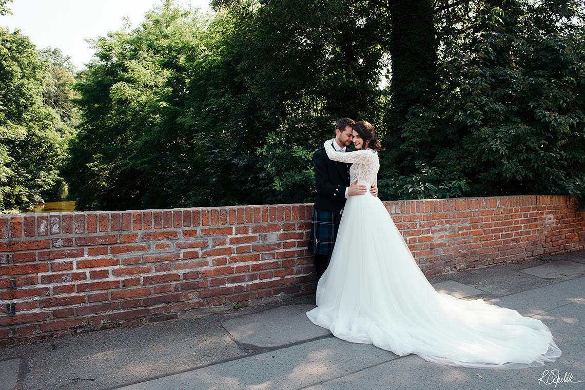 Wedding photography of bride and groom on small bridge in Prague