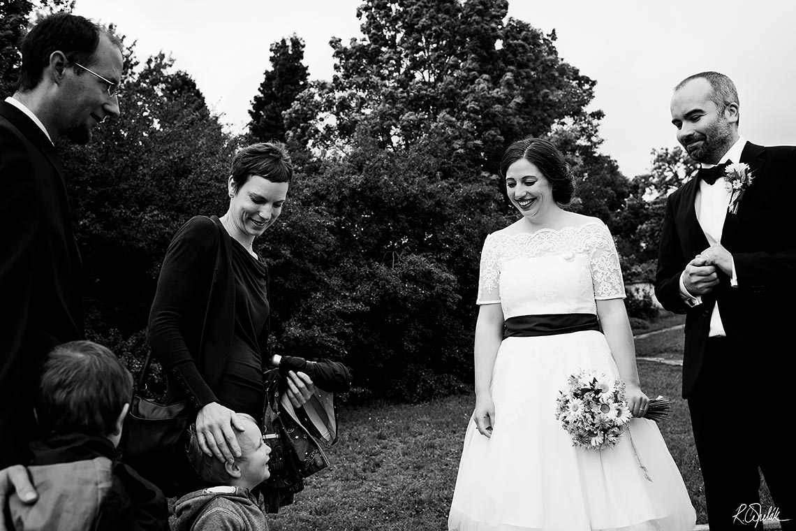 wedding snapshot of child with bride and groom
