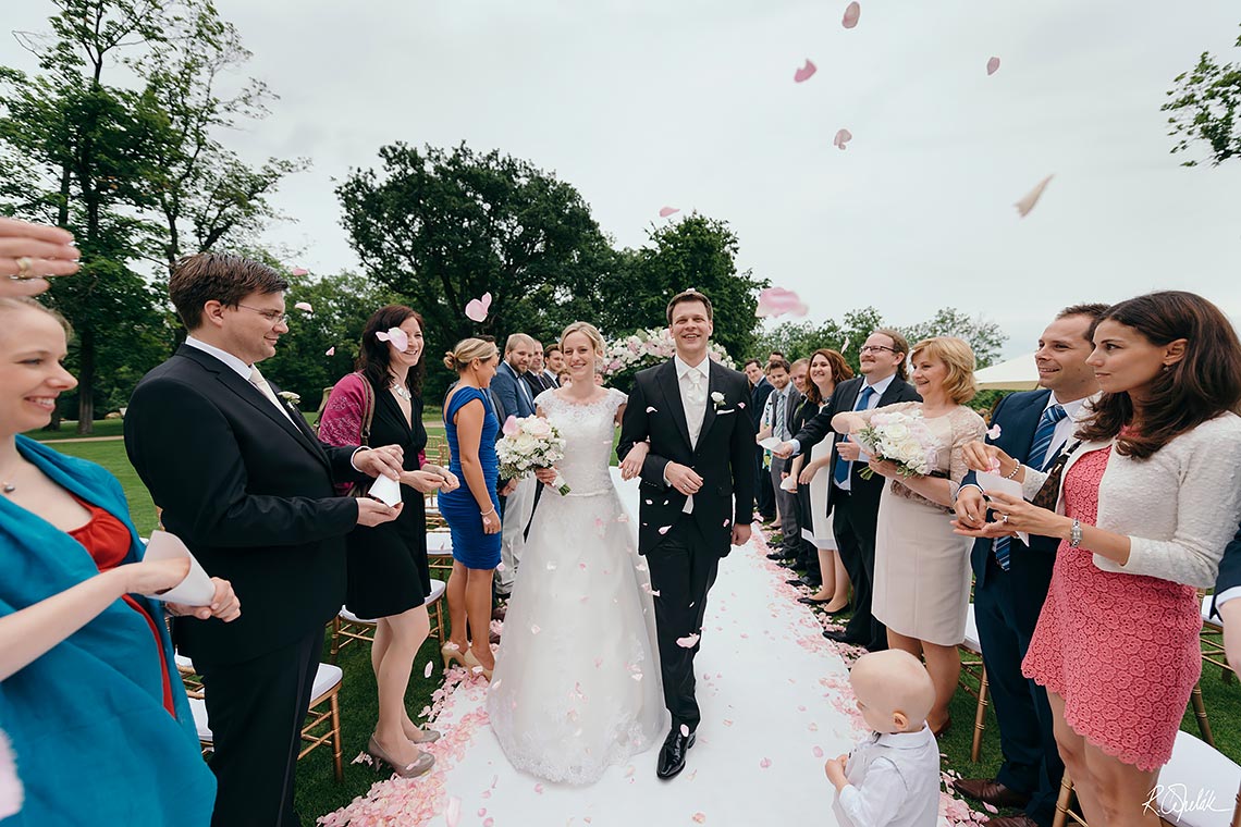 bride and groom leaving ceremony wedding at Chateau Mcely in Czech Republic