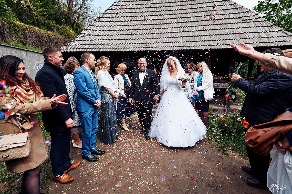 bride and groom leaving orthodox wedding ceremony in Prague