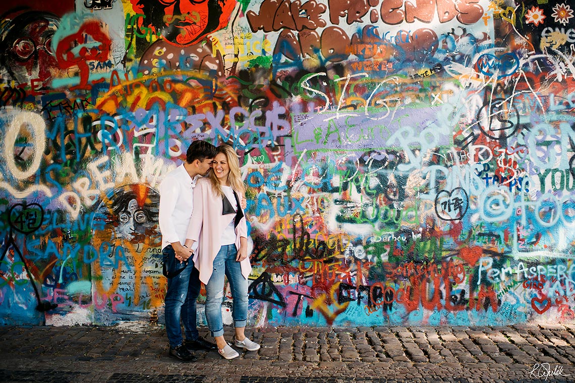 prewedding photography of symphatetic couple by the Lennon wall