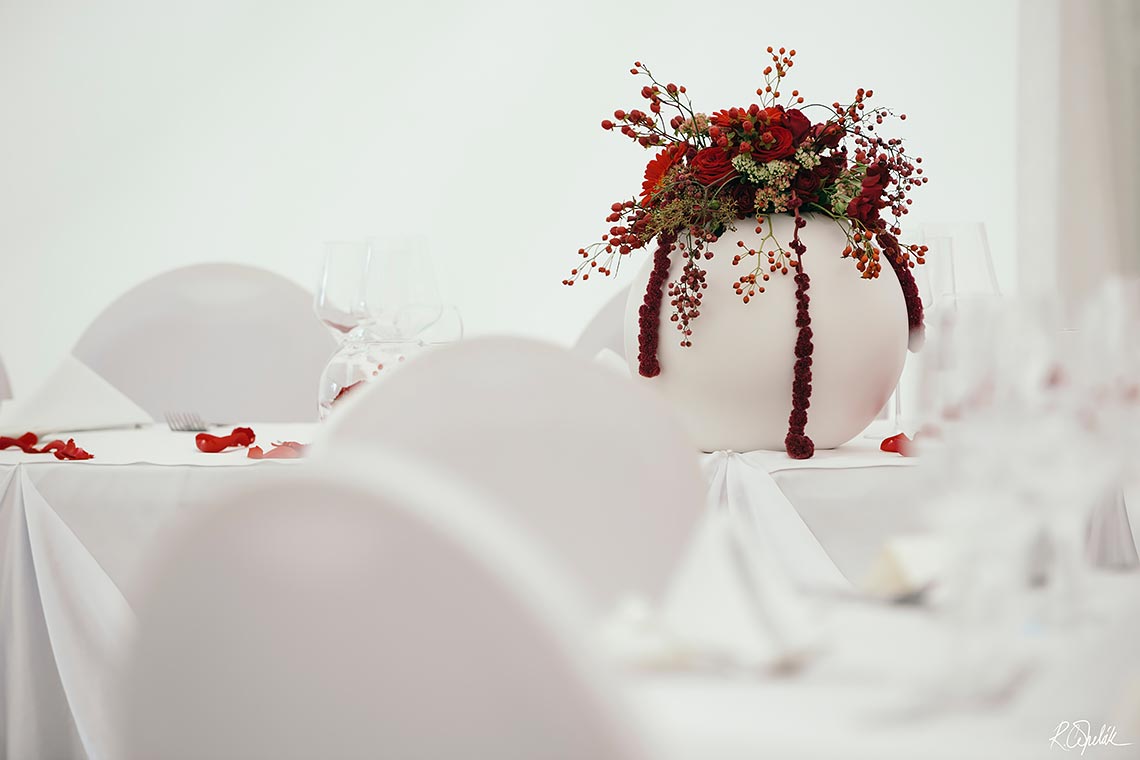wedding reception with red flowers at Chateau St. Havel in Prague