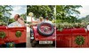 bride and groom in red vintage convertible car