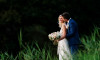 wedding photography of bride and groom with grass in the nature